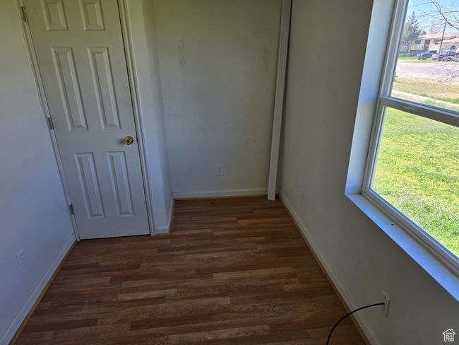 Interior space with baseboards and dark wood-type flooring | Image 6