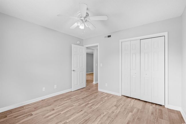 Unfurnished bedroom with light wood-style flooring, a closet, and a ceiling fan | Image 18