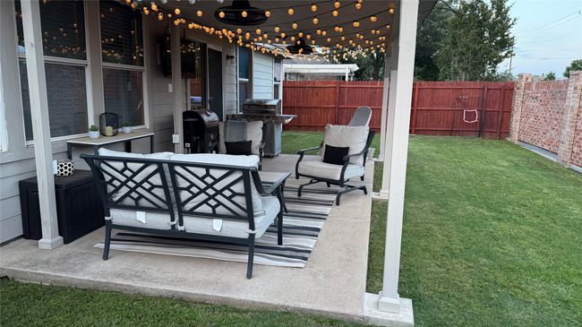 View of patio with area for grilling, an outdoor hangout area, and ceiling fan | Image 24