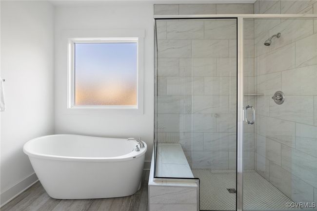 Luxurious primary bath with double vanity, soaking tub, and spa-inspired design. | Image 26