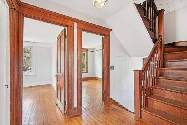 Hallway featuring stairway, light wood finished floors, and baseboards | Image 27