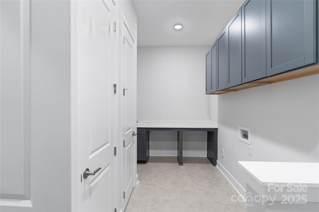 Laundry room with folding table | Image 16