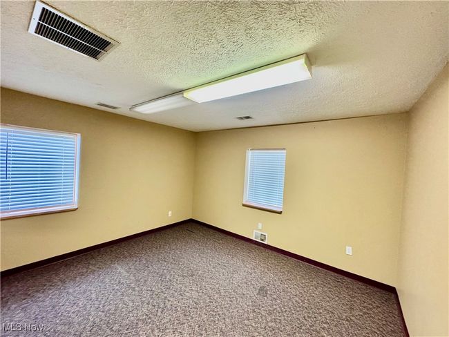 Empty room featuring carpet flooring and a textured ceiling | Image 13