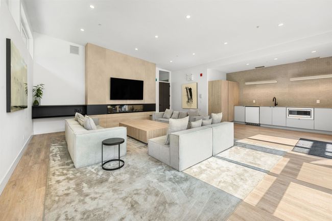 Living area with light wood-type flooring, recessed lighting, baseboards, and visible vents | Image 26