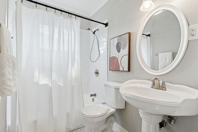Darling full bath with tiled shower-tub combo. | Image 24