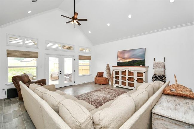 Living room with windows and doors opening to covered patio | Image 28