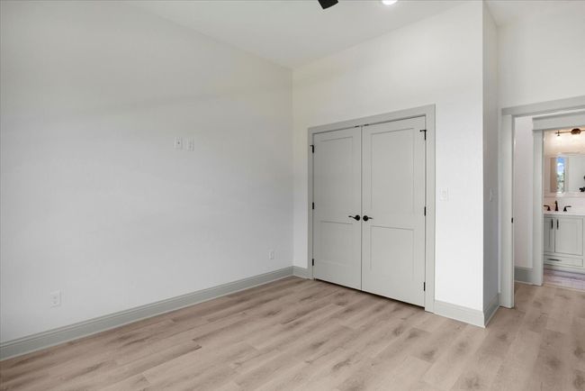 Unfurnished bedroom featuring light wood-type flooring, a closet, and ceiling fan | Image 34