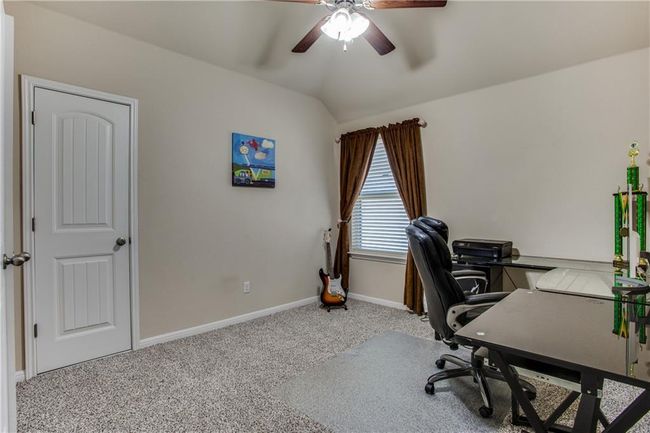 Carpeted office with a ceiling fan and lofted ceiling | Image 20