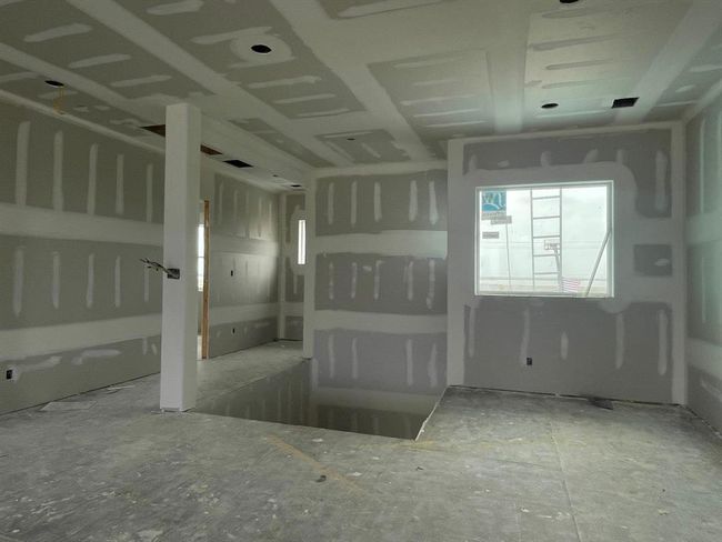 From this angle, you can see the open layout upstairs with space for a cozy reading nook beneath the stairs and elevator access just behind—showcasing the blend of design and function throughout the home. | Image 40