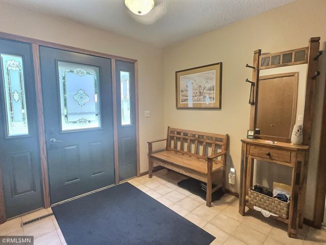 Another view of the entryway. Front loading washer and dryer are located in the closet. | Image 20