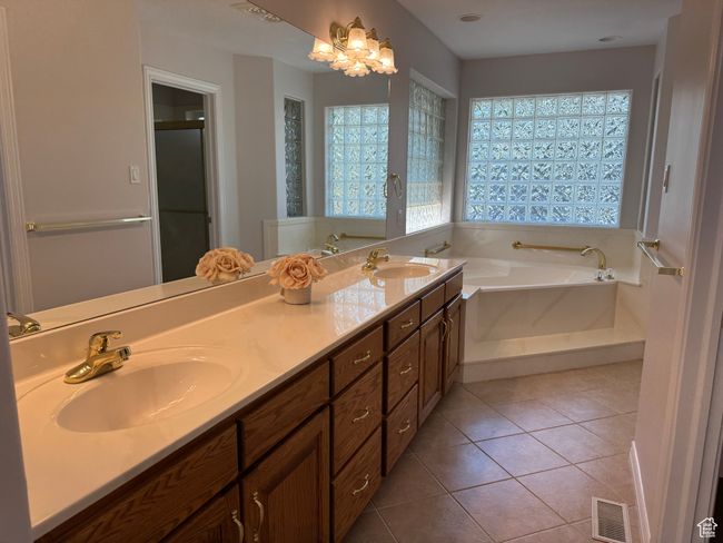 Primary bathroom with dual sink vanity, jetted tub, separate shower and tile floor. | Image 14