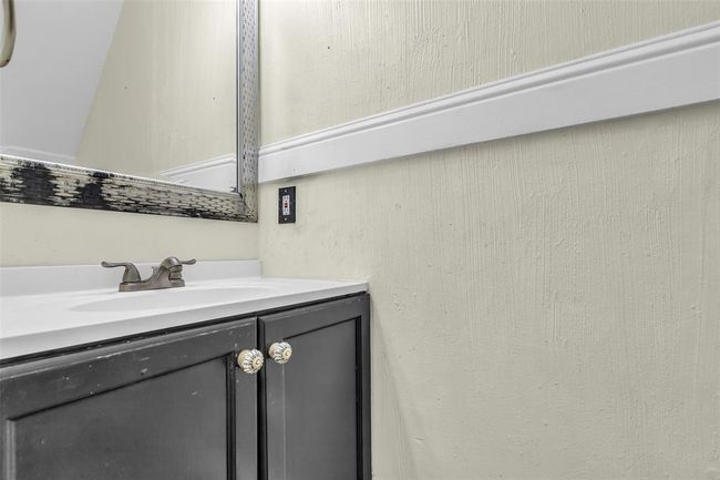 The half bath is conveniently located under the staircase leading to the second floor. | Image 17