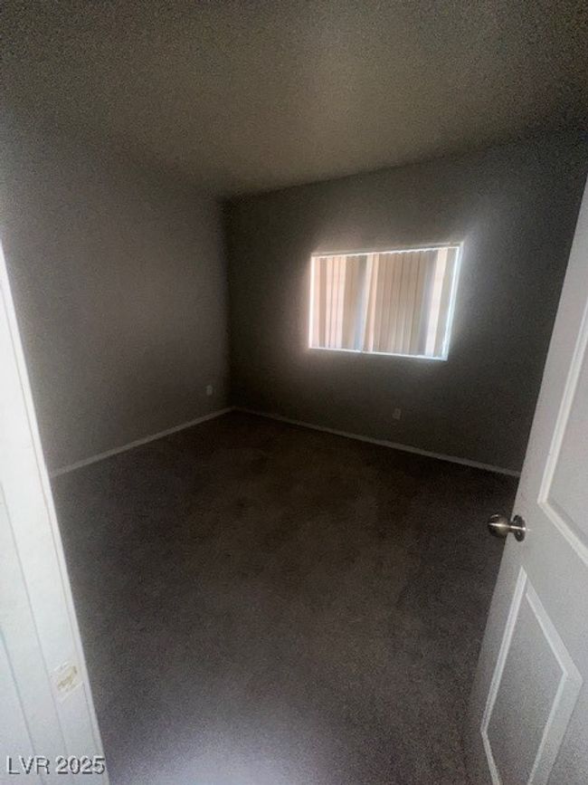 Spare room with dark carpet and baseboards | Image 6