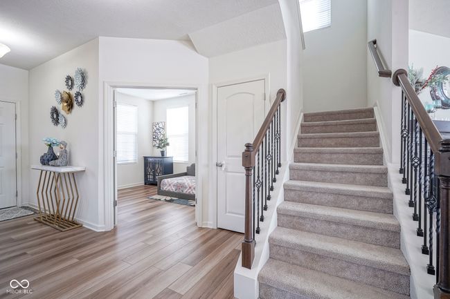 stairway with baseboards and wood finished floors | Image 11