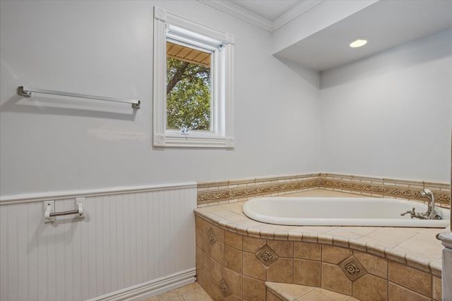 Full bath with a garden tub, a wainscoted wall, ornamental molding, and tile patterned floors | Image 20