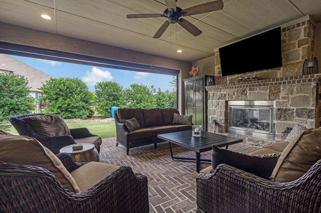View of patio with an outdoor living space with a fireplace and ceiling fan | Image 29