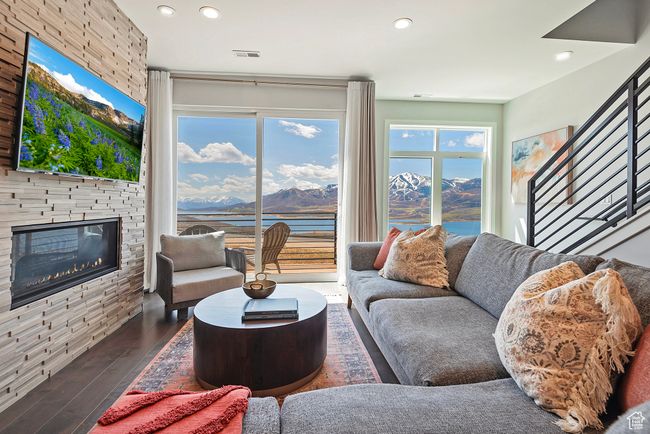 Living area featuring recessed lighting, wood finished floors, visible vents, a mountain view, and a fireplace | Image 4