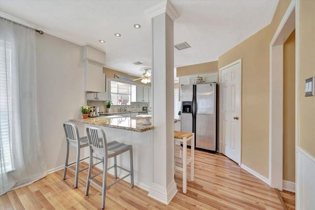 The kitchen has been remodeled and opened up to the eating area and family room and offers a great eating bar as well. | Image 16