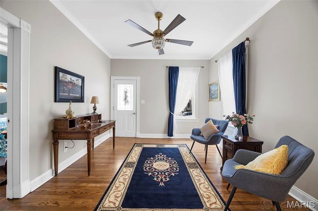 Foyer entrance with ornamental molding, a ceiling fan, and wood finished floors | Image 4