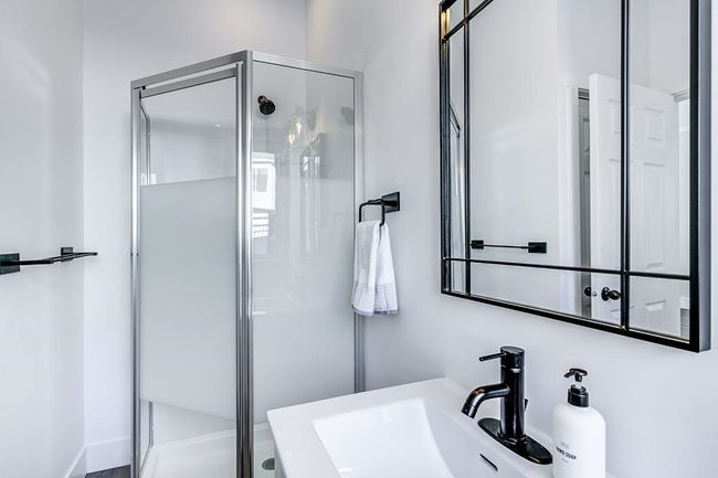 Bathroom featuring a shower stall and a sink | Image 23