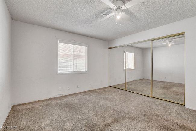Unfurnished bedroom featuring a textured ceiling, a closet, carpet flooring, and ceiling fan | Image 20