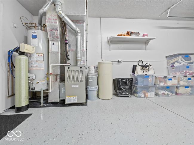 utility area in the garage with gas water heater , water softener (rented) and epoxy sealed floor | Image 18