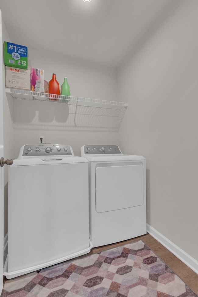 The upstairs laundry room is perfectly situated for easy access to all four upstairs bedrooms and includes a nearly new washer and dryer, making laundry a breeze! | Image 36