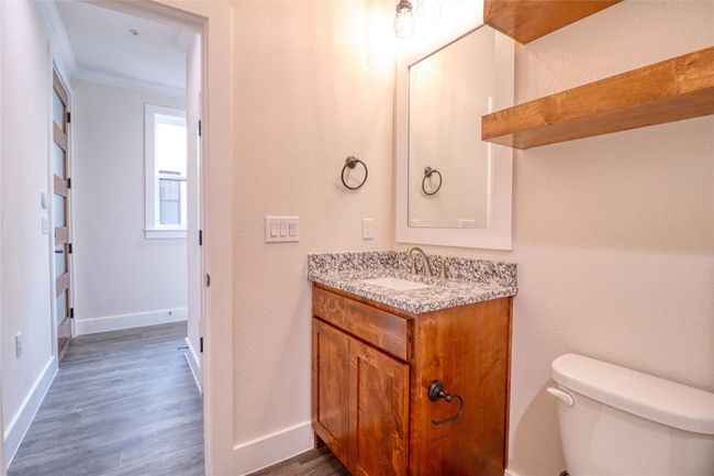 Bathroom featuring vanity, hardwood / wood-style floors, ornamental molding, and toilet | Image 19