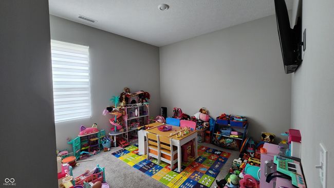 Bedroom on main floor with carpet flooring and a textured ceiling | Image 10