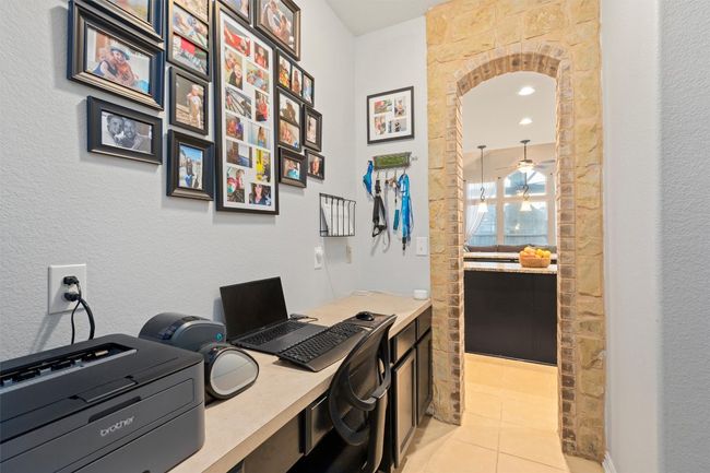 Office space with light tile patterned floors and ceiling fan | Image 21