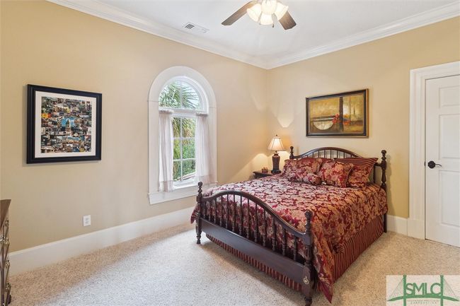 The third bedroom looks out over the pool area and backyard. | Image 34