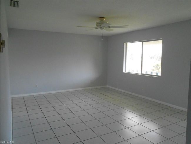 Empty room with baseboards, visible vents, and a ceiling fan | Image 6