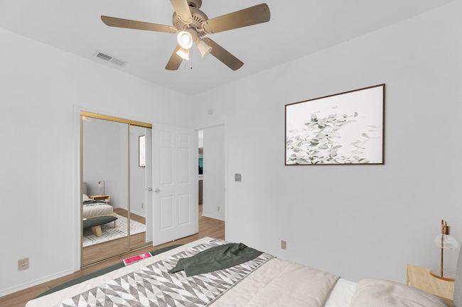 Bedroom featuring wood finished floors, a closet, and a ceiling fan | Image 23