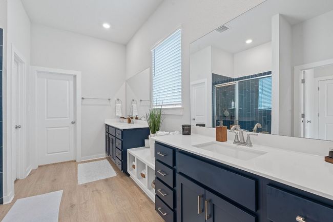 Bathroom with a shower stall, two vanities, wood finished floors, and a sink | Image 15