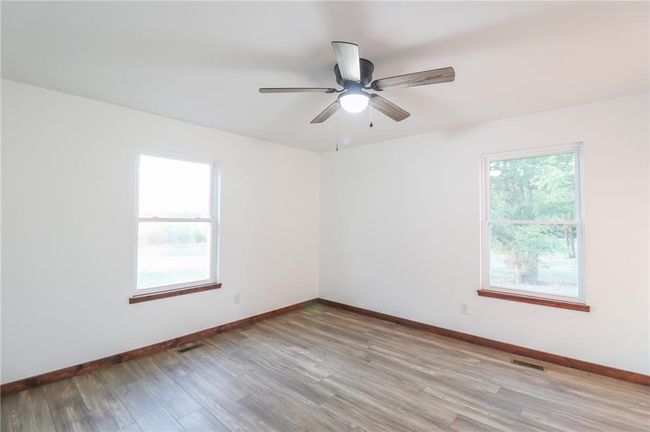 Empty room with ceiling fan and light hardwood / wood-style floors | Image 29