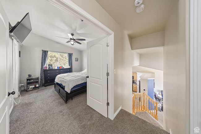 Carpeted bedroom with lofted ceiling and ceiling fan | Image 17