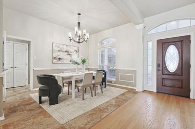 Dining space featuring a chandelier, beamed ceiling, and light wood-type flooring | Image 2