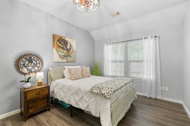 This fourth bedroom features a walk in closet, ceiling fan and tile floors. | Image 36