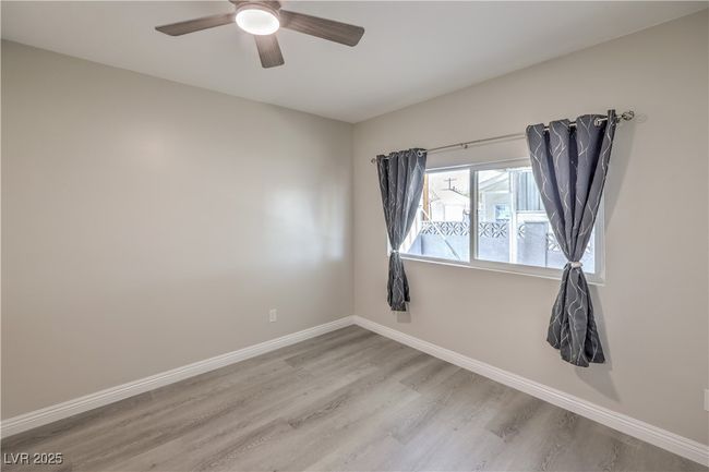 Spare room with ceiling fan, wood finished floors, and baseboards | Image 26