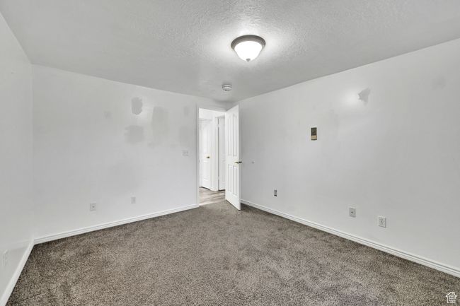 Carpeted spare room featuring baseboards and a textured ceiling | Image 32