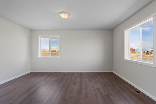 Empty room with baseboards, visible vents, and dark wood finished floors | Image 44