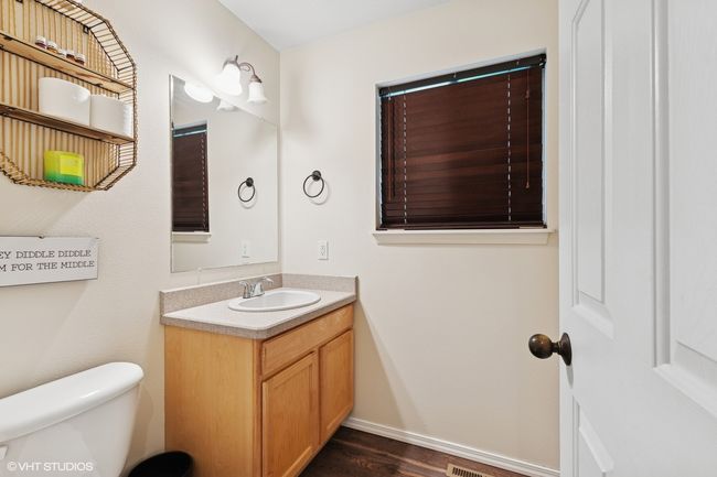 Bathroom with vanity, toilet, wood finished floors, and baseboards | Image 15