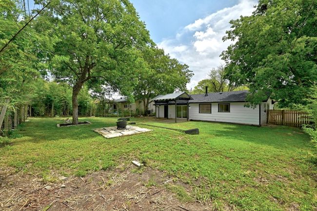 Fenced backyard with a fire pit and a patio | Image 27
