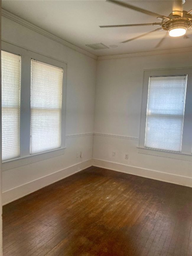 Unfurnished 2nd room featuring dark wood-type flooring, crown molding, and a ceiling fan | Image 8