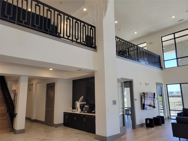 Living room featuring baseboards, visible vents, a towering ceiling, marble finish floor, and stairway | Image 25