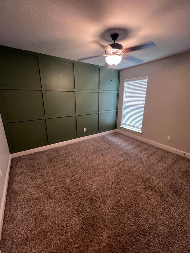 Unfurnished bedroom with carpet floors, baseboards, ceiling fan, and a textured ceiling | Image 34
