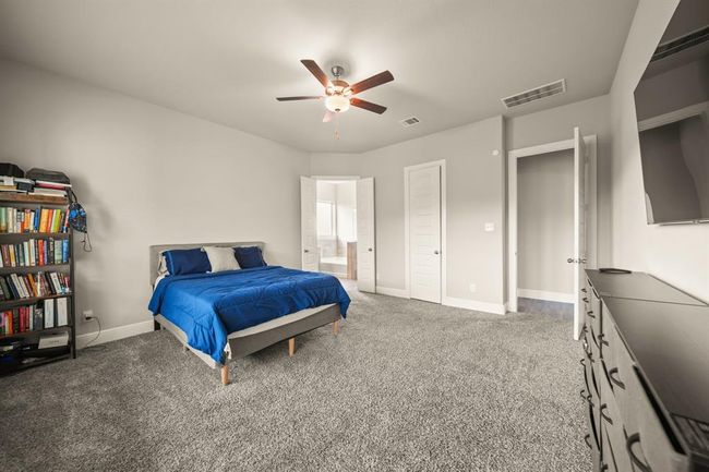 Double-door entry to a tranquil owner's suite with an ensuite bath and ample space. | Image 17
