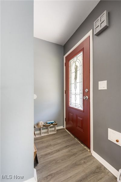 Entryway featuring wood-type flooring and baseboard heating | Image 2