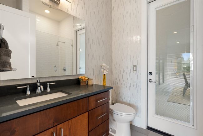 A stylish and functional full bath offers direct pool access and high-end finishes. | Image 24
