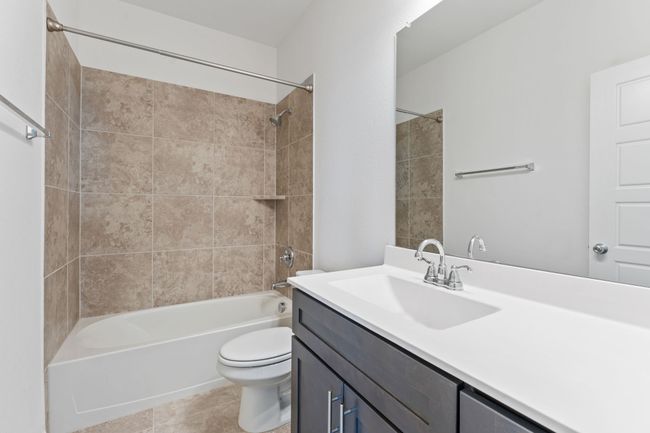Bathroom with vanity, shower combination, toilet, and tile patterned floors | Image 19